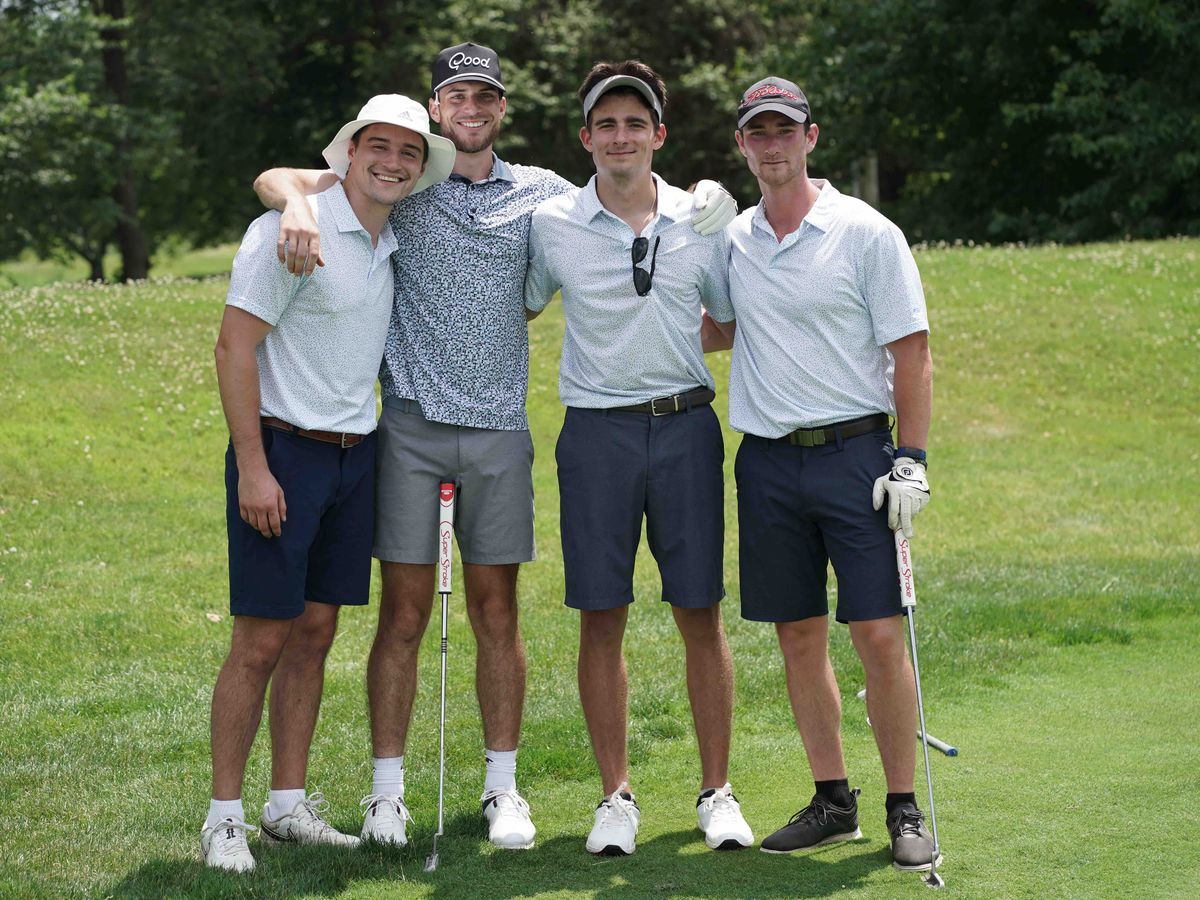 Chris with friends on a golf course